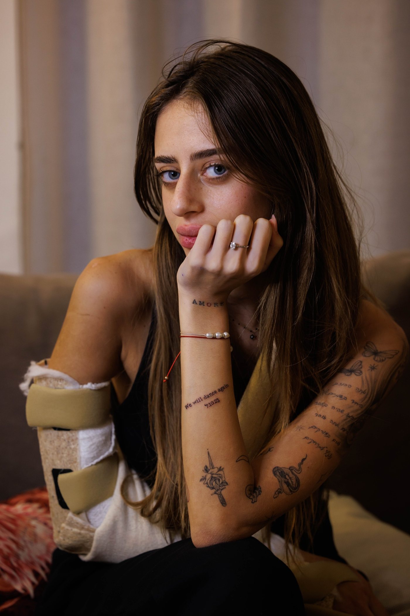 Mia Schem, with We Will Dance Again tattooed on her arm